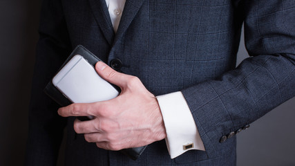 businessman in suit holding smartphone
