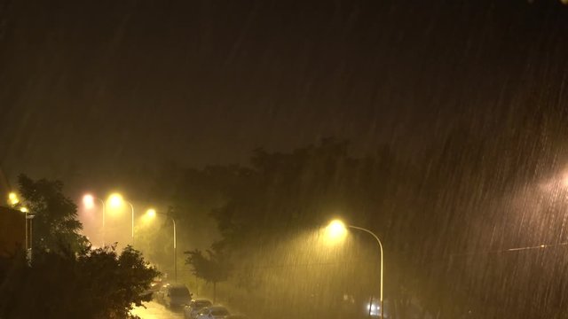Rain storm and lightning in the city at night