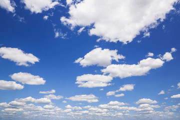 Blue sky with white puffy clouds. Clouds in the blue sky.