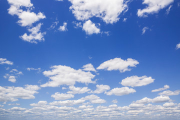 Blue sky with white puffy clouds. Clouds in the blue sky.