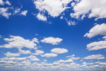 Blue sky with white puffy clouds. Clouds in the blue sky.