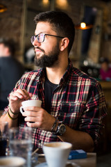 Bearded man in a coffee bar