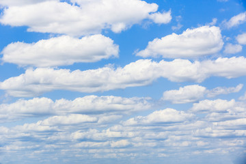 Blue sky with white puffy clouds. Clouds in the blue sky.