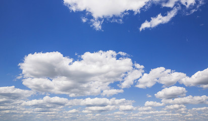 Fototapeta premium Blue sky with white puffy clouds. Clouds in the blue sky.
