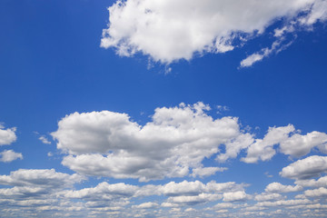 Fototapeta premium Blue sky with white puffy clouds. Clouds in the blue sky.