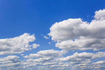 Blue sky with white puffy clouds. Clouds in the blue sky.