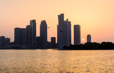 Fototapeta na wymiar Modern city sunset scene at the waterfront