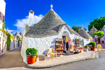 Alberobello, Puglia, Italy: Typical houses built with dry stone walls and conical roofs, in a beautiful day, Apulia - obrazy, fototapety, plakaty