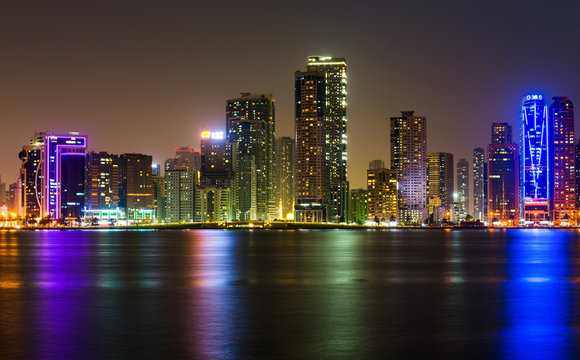 Sharjah waterfront cityscape in UAE at night