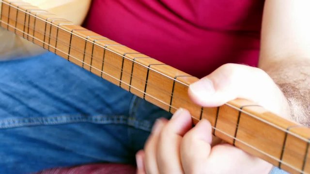 Turkish saz of the musical instrument,
Man playing Turkish saz

