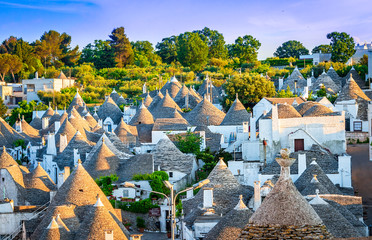 Alberobello, Puglia, Italy: Cityscape over the traditional roofs of the Trulli, original and old houses of this region, Apulia - obrazy, fototapety, plakaty