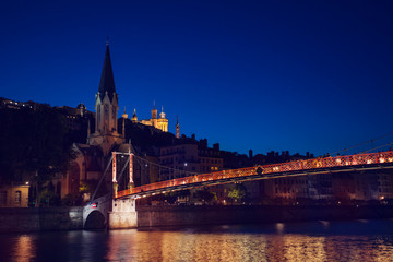 Fototapeta na wymiar St. Georges church and footbridge at night, Lyon