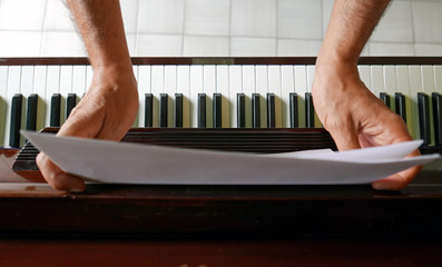  sheet music over piano keyboard