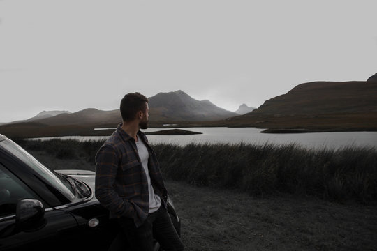Man sitting looking at the mountains 