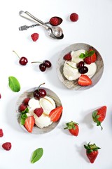 Obraz na płótnie Canvas Vanilla ice cream with berries isolated. Ice cream bowl with cherry, raspberry and strawberry