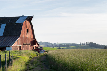 Palouse barn with old car at edge of field