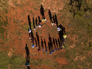 Aerial view of children playing with teachers of 