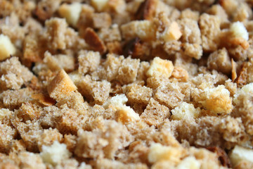 Finely chopped rusks. Dried bread diced. Close-up. Background.