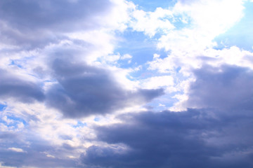 Naklejka na ściany i meble A beautiful cloudy sky, cumulus clouds and scorching sun. Background. Landscape.