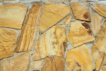 Concrete wall gold color. Decorative rock. Background. Texture.