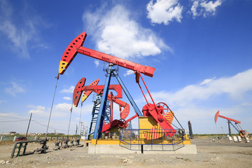 Oil pumps are working in the blue sky background