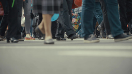 People pedestrians walks across a busy city street