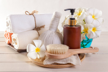 Obraz na płótnie Canvas Spa massage and body scrub with towels compress balls and flowers