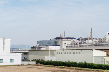 Fototapeta na wymiar Factory building in the suburbs, industrial plant background
