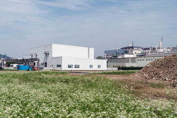Factory building in the suburbs, industrial plant background