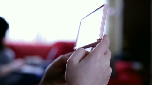 Child Plays Handheld Video Game System In Living Room.
