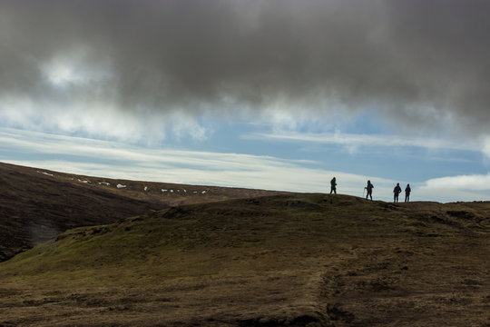 Group of hikers in the distance of the serene hills on Isle of Skye, Scotland