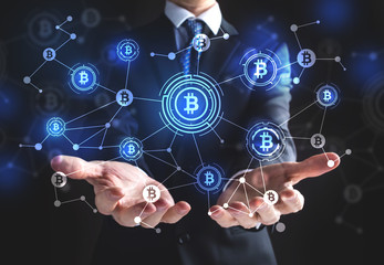 Obraz premium Bitcoin with businessman on a black background 