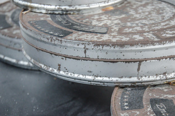 Stacked old and rusted film reels 