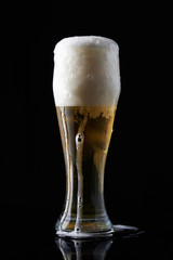 Full beer glass with a lot of foam