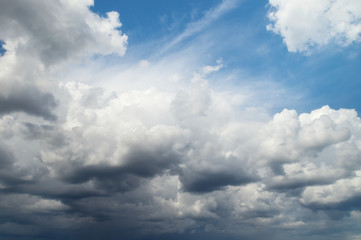 Dark rain clouds in the blue sky