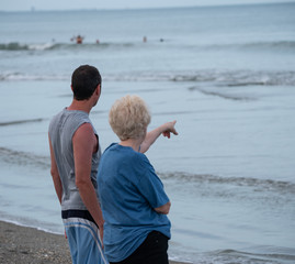 unknown senior tells a story to a passing tourist