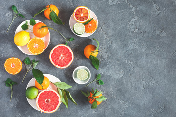 Fruit background. Colorful fresh fruits on black background. Orange, tangerine, lime, lemon, grapefruit. Flat lay, top view