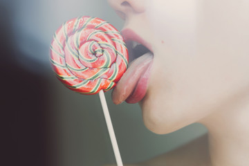 Seductive female licking lollipop