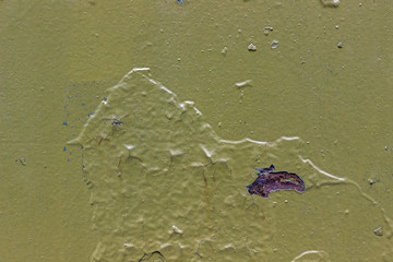 Green metal background with peeling, cracked paint and rusty spot.