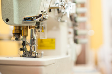 Close-up of modern sewing machine foot with copy space. Focus on needle