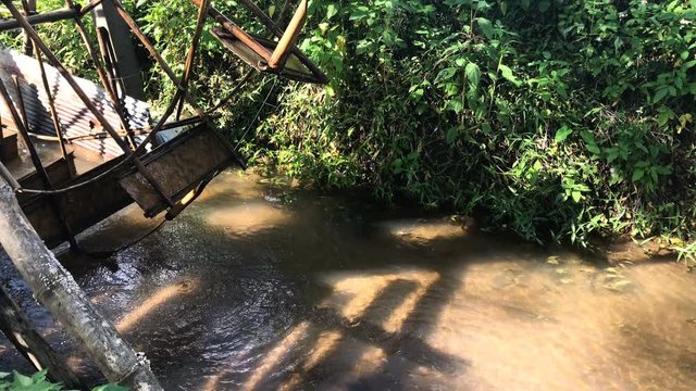 Water turbine made of bamboo in clean energy stream.