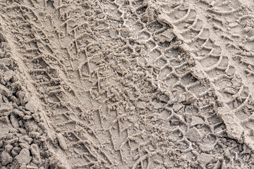 traces of car tires on dirty snow