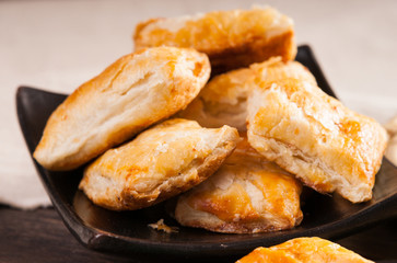 Pie made from puff pastry with meat on plate 