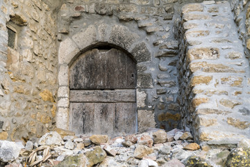 old wood woor in a stone wall of an house in france
