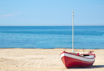 red fishing boat on the beach with blue ocean background in Denmark