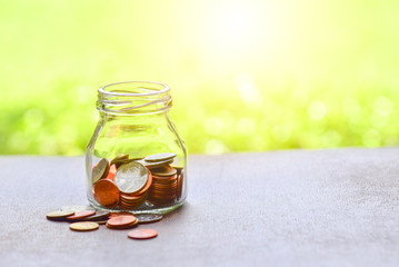 Glass Jar Filled with Bronze Coins for Savings