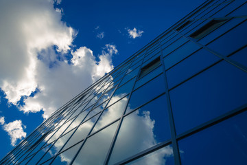 Abstract modern office building. Reflections of the sky in the glass surface.