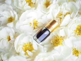 Obraz na płótnie Canvas Arabian oudh attar perfume or agarwood oil fragrances with Rose in mini bottle.