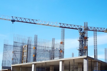Construction and crane on a blue sky background.
