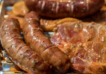 Unhealthy but tasty grilled sausages and meat